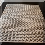 DR06. Black and white wool rug. Measures approx. 7'4” x 5'2” 
